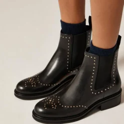 Chelsea wing tip boots in studded leather