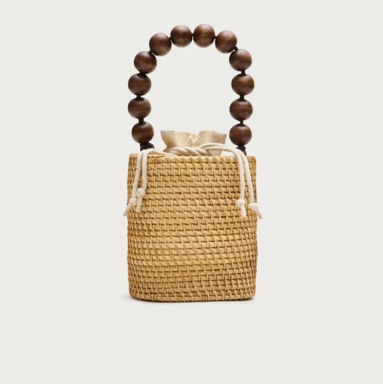 Handknotted rattan bucket bag with wood beads